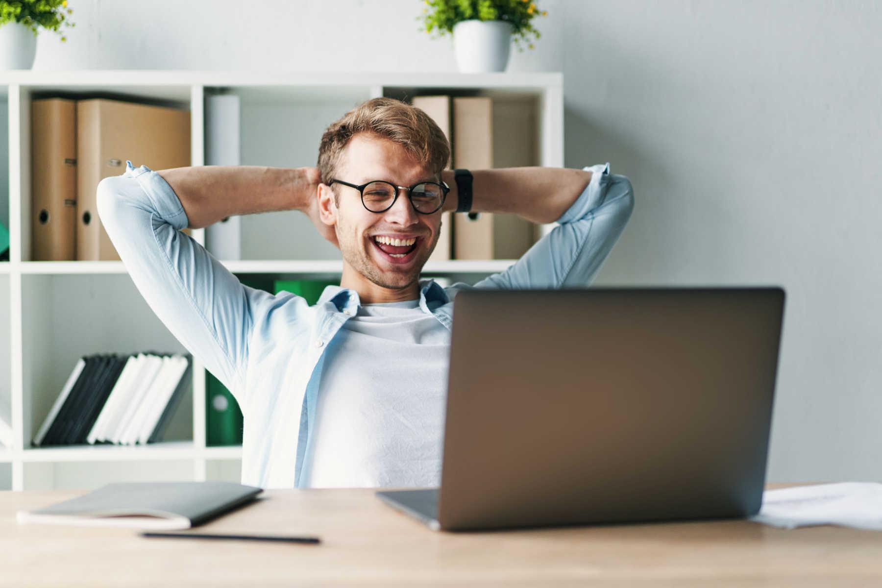 Man looking at computer and laughing